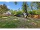 Lush backyard with green lawn, mature trees, wooden fence, and view of the house at 1280 Sherry Dr, Alpharetta, GA 30009