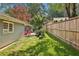 This backyard features a fenced lawn, string lights, and a charming outdoor space, perfect for relaxation at 1280 Sherry Dr, Alpharetta, GA 30009