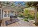 Cozy backyard patio with pergola, string lights, outdoor seating, garden, and French doors at 1280 Sherry Dr, Alpharetta, GA 30009
