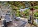 Relaxing backyard patio with a pergola, string lights, lounge chairs, plants, and a fountain at 1280 Sherry Dr, Alpharetta, GA 30009
