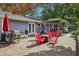 Backyard with a brick patio, pergola, outdoor seating, grills, and mature trees at 1280 Sherry Dr, Alpharetta, GA 30009