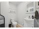 Compact powder room featuring a toilet, vanity, faucet, mirror, and neutral wall colors at 1280 Sherry Dr, Alpharetta, GA 30009