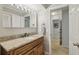 Bright bathroom showcasing a granite countertop vanity and an entrance hallway at 1280 Sherry Dr, Alpharetta, GA 30009