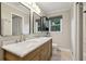Well-lit bathroom featuring double mirrors and a warm wooden vanity with ample countertop space at 1280 Sherry Dr, Alpharetta, GA 30009