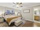 Comfortable bedroom with an upholstered bench, a warm throw blanket, and natural light at 1280 Sherry Dr, Alpharetta, GA 30009