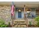 Inviting front porch with stone steps, charming decor, and an American flag at 1280 Sherry Dr, Alpharetta, GA 30009
