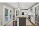 Spacious kitchen with an island, stainless steel appliances, and white cabinetry at 1280 Sherry Dr, Alpharetta, GA 30009