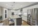 Modern kitchen features a large island with seating, stainless steel appliances, and white cabinets at 1280 Sherry Dr, Alpharetta, GA 30009