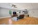 Spacious living room with a bar area, ceiling fans, hardwood floors, and neutral colors at 1280 Sherry Dr, Alpharetta, GA 30009