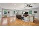 Open living room features hardwood floors, ceiling fans, and natural light from multiple windows at 1280 Sherry Dr, Alpharetta, GA 30009