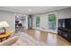 Cozy living room with hardwood floors, neutral furniture, and an open view to a home office at 1280 Sherry Dr, Alpharetta, GA 30009