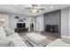 Cozy living room with gray brick fireplace, ceiling fan, and plush white sofa at 1280 Sherry Dr, Alpharetta, GA 30009
