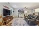 Living room with TV, rocking chair, ceiling fan, a bar and hardwood floors at 1280 Sherry Dr, Alpharetta, GA 30009