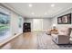 Living room featuring hardwood floors, neutral colors, large windows, and comfortable seating at 1280 Sherry Dr, Alpharetta, GA 30009