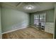 A carpeted bedroom offers a window for natural light and includes storage cabinets at 1959 Christian Circle, Conyers, GA 30013