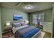 Virtually staged bedroom features a comfortable bed with scenic wall art at 1959 Christian Circle, Conyers, GA 30013