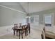 Dining room with a dark wooden table, gray walls, white trim, and tile flooring at 1959 Christian Circle, Conyers, GA 30013