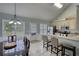 Bright kitchen with stainless appliances, large window, counter seating, and an adjacent dining area at 1959 Christian Circle, Conyers, GA 30013