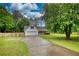 Spacious single-Gathering home with a long driveway and expansive front yard filled with mature trees at 1959 Christian Circle, Conyers, GA 30013