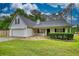 Inviting single-Gathering home featuring a two-car garage, and a cozy front porch with manicured landscaping at 1959 Christian Circle, Conyers, GA 30013