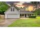 Charming single-Gathering home featuring a two-car garage, inviting front porch, and lush green lawn at 1959 Christian Circle, Conyers, GA 30013