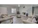 Inviting living room with a fireplace, hard surface floors, neutral walls, and two comfortable sofas at 1959 Christian Circle, Conyers, GA 30013
