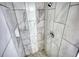 Beautiful shower with marble-patterned tiling and mosaic tile floor at 1959 Christian Circle, Conyers, GA 30013