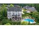 Expansive estate featuring a stunning pool, lush landscaping, and multi-level balconies for luxurious outdoor living at 212 Fernwood Pl, Woodstock, GA 30188