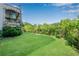A vast, level backyard featuring verdant lawn and mature landscaping, ideal for outdoor activities and gatherings at 212 Fernwood Pl, Woodstock, GA 30188
