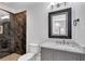 Bathroom with modern vanity and sleek glass shower featuring decorative tile at 212 Fernwood Pl, Woodstock, GA 30188