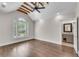 Bedroom featuring hardwood floors, a ceiling fan, and a glimpse into the bathroom at 212 Fernwood Pl, Woodstock, GA 30188