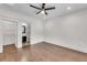 Spacious bedroom with hardwood floors, offering an attached walk in closet and bathroom at 212 Fernwood Pl, Woodstock, GA 30188
