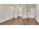 Bright bedroom features hardwood floors, white trim and a closet with wire shelves at 212 Fernwood Pl, Woodstock, GA 30188
