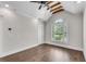 Bright bedroom features wood-beamed ceiling, ceiling fan, and plantation shutters for natural light at 212 Fernwood Pl, Woodstock, GA 30188