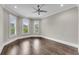Bright bedroom boasts hardwood floors, neutral paint, crown molding, and a bank of windows at 212 Fernwood Pl, Woodstock, GA 30188