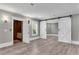 An open bonus room with plank flooring and custom barn doors, also features an elevator for easy access at 212 Fernwood Pl, Woodstock, GA 30188