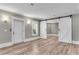 An open bonus room features plank flooring, white trim, and custom barn doors for a flexible living space at 212 Fernwood Pl, Woodstock, GA 30188