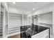 Closet featuring a black marble island, white cabinetry, shelving and drawers at 212 Fernwood Pl, Woodstock, GA 30188
