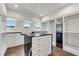 Custom closet with central island, white cabinetry and drawers, and dark countertops at 212 Fernwood Pl, Woodstock, GA 30188
