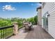Outdoor deck with wooded view and table seating provides the perfect outdoor space at 212 Fernwood Pl, Woodstock, GA 30188
