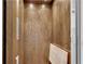 Interior view of an elevator with wood paneling, controls, and lighting for convenient multi-floor access at 212 Fernwood Pl, Woodstock, GA 30188