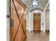 Spacious foyer featuring a sliding barn door, brick ceiling and hardwood floors at 212 Fernwood Pl, Woodstock, GA 30188