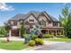 Elegant home featuring a manicured lawn, mature landscaping, and inviting curb appeal at 212 Fernwood Pl, Woodstock, GA 30188