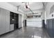 Clean garage with gray cabinets, workbench, and coated flooring, designed for organization and efficiency at 212 Fernwood Pl, Woodstock, GA 30188
