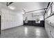 Spacious three-car garage with custom built-in storage cabinets and epoxy flooring to accommodate organization and car care at 212 Fernwood Pl, Woodstock, GA 30188