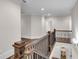 Second floor hallway with a wrought iron railing and hardwood flooring at 212 Fernwood Pl, Woodstock, GA 30188