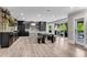 A spacious kitchen with black accents, a large island, bar shelves and access to the patio at 212 Fernwood Pl, Woodstock, GA 30188