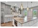 Bright, modern kitchen with grey cabinetry, stainless steel appliances, and a large center island at 212 Fernwood Pl, Woodstock, GA 30188