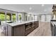 Large kitchen island with built in stainless steel ovens and views to additional living space at 212 Fernwood Pl, Woodstock, GA 30188