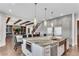A modern kitchen provides access to the living room with a centrally located staircase at 212 Fernwood Pl, Woodstock, GA 30188